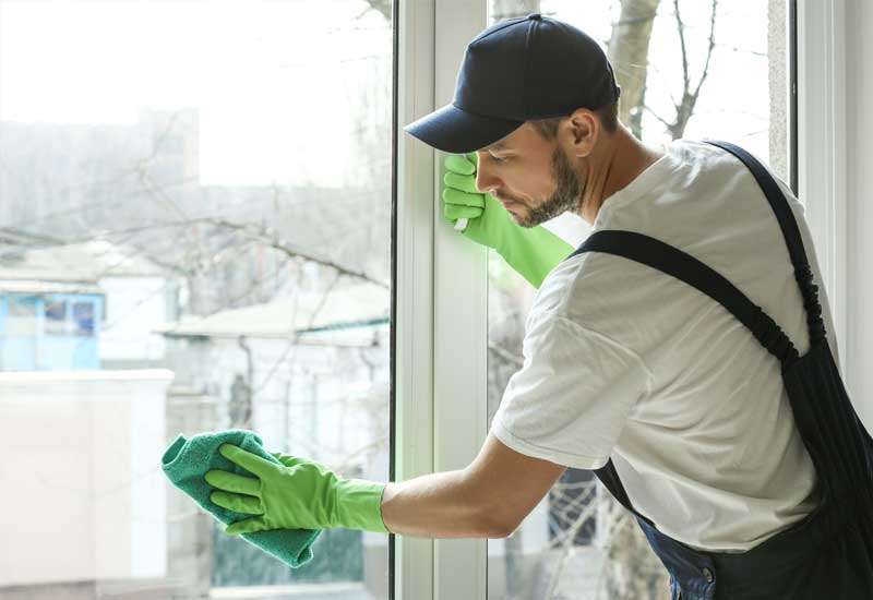 man cleaning window