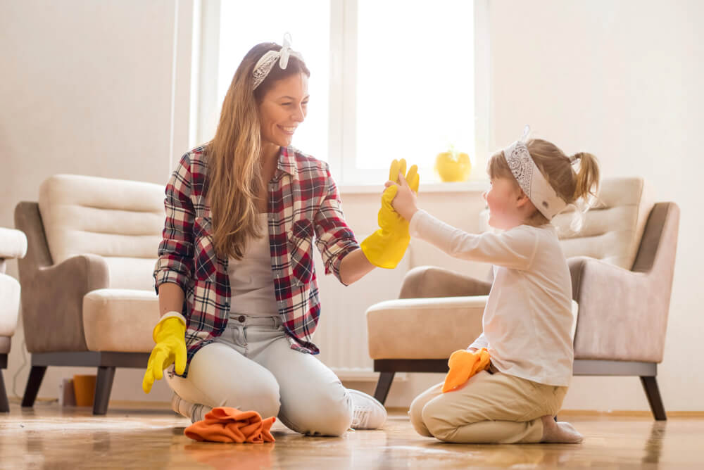 child helping their mother to clean the house.